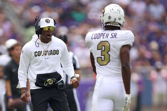 Colorado Buffaloes head coach Deion Sanders yells at cornerback Omarion Cooper.